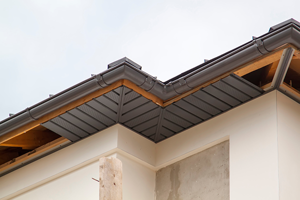 Image looking up at a residential roof where you can see that some soffit has been installed.